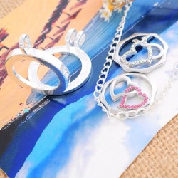 1 médaillon cage, vitré + 2 pièces interchangeables motifs cœurs doubles entrelacés :2 modèles différents / strass roses + str